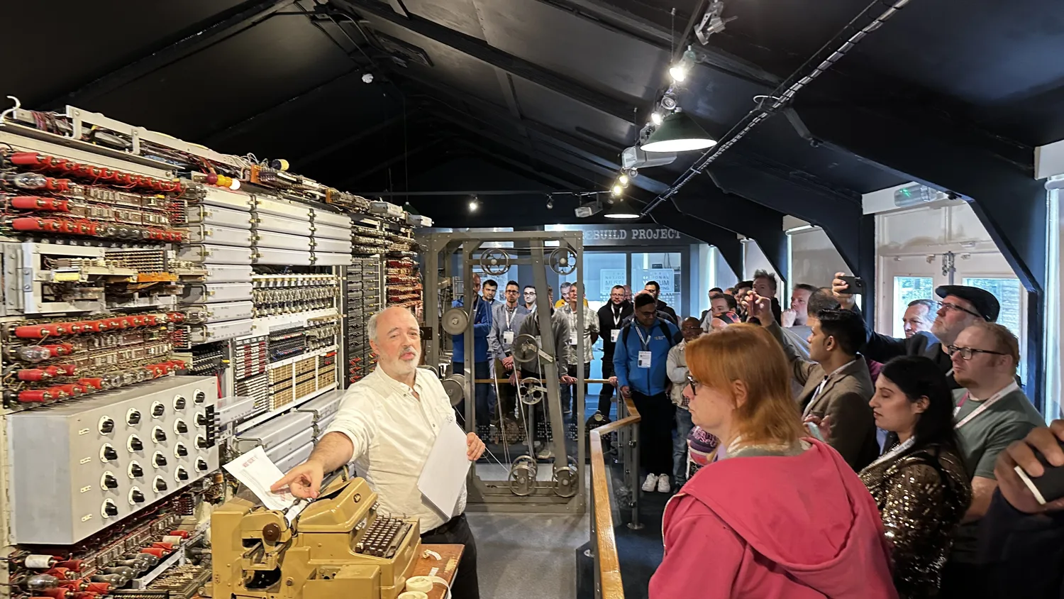 Interactive exhibit at The National Museum of Computing showing vintage computing equipment with attendees engaging with the technology