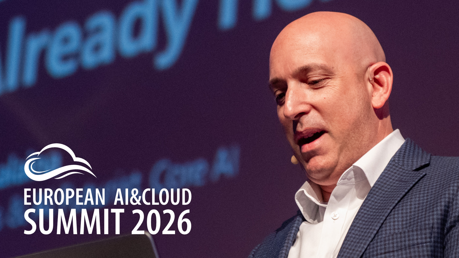 Marco Casalaina presents at a conference with a backdrop displaying 'European AI & Cloud Summit 2026.' The scene captures an engaging speaker addressing an event focused on AI and cloud technology.