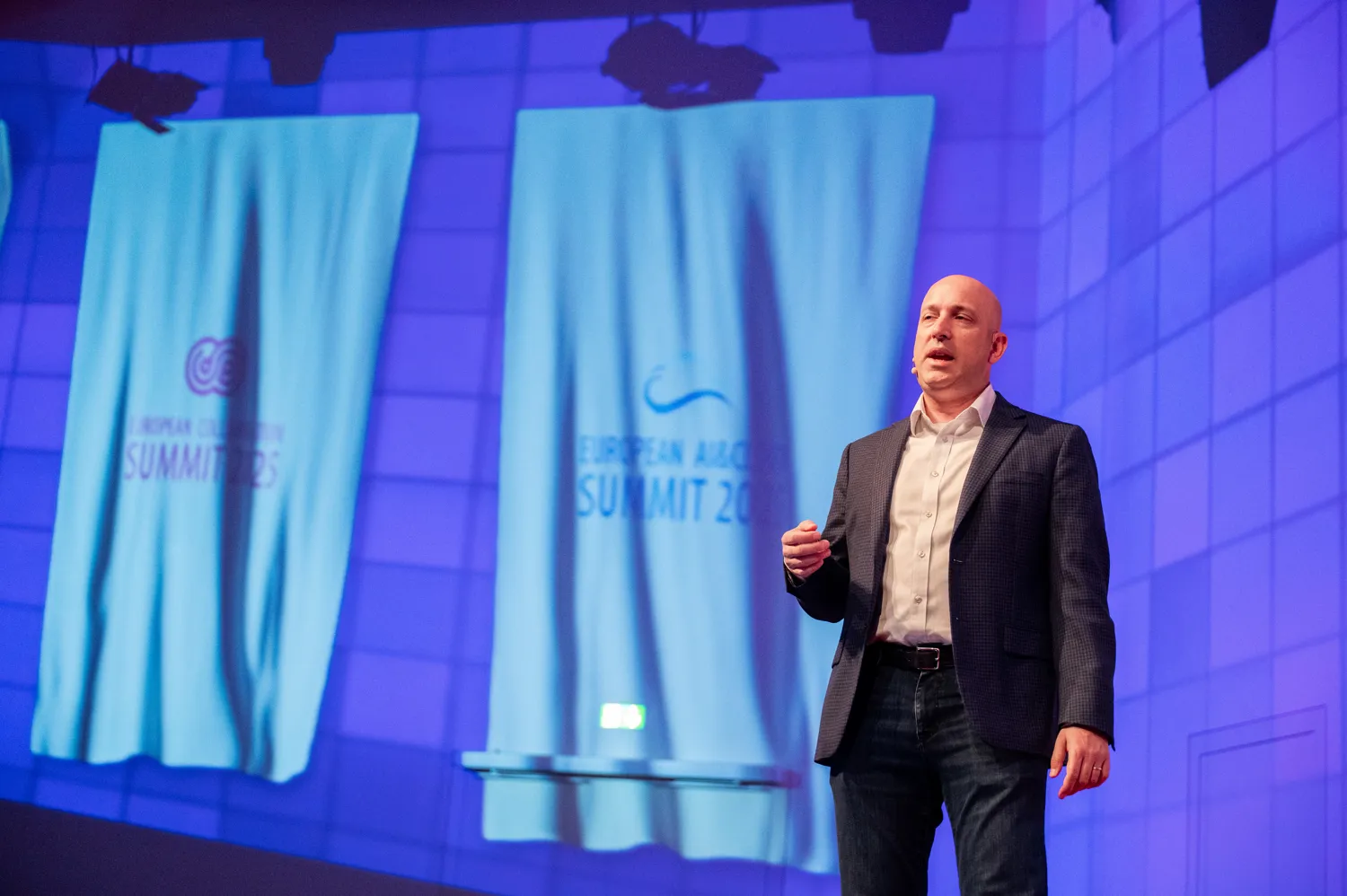 A speaker presenting on an ECS stage