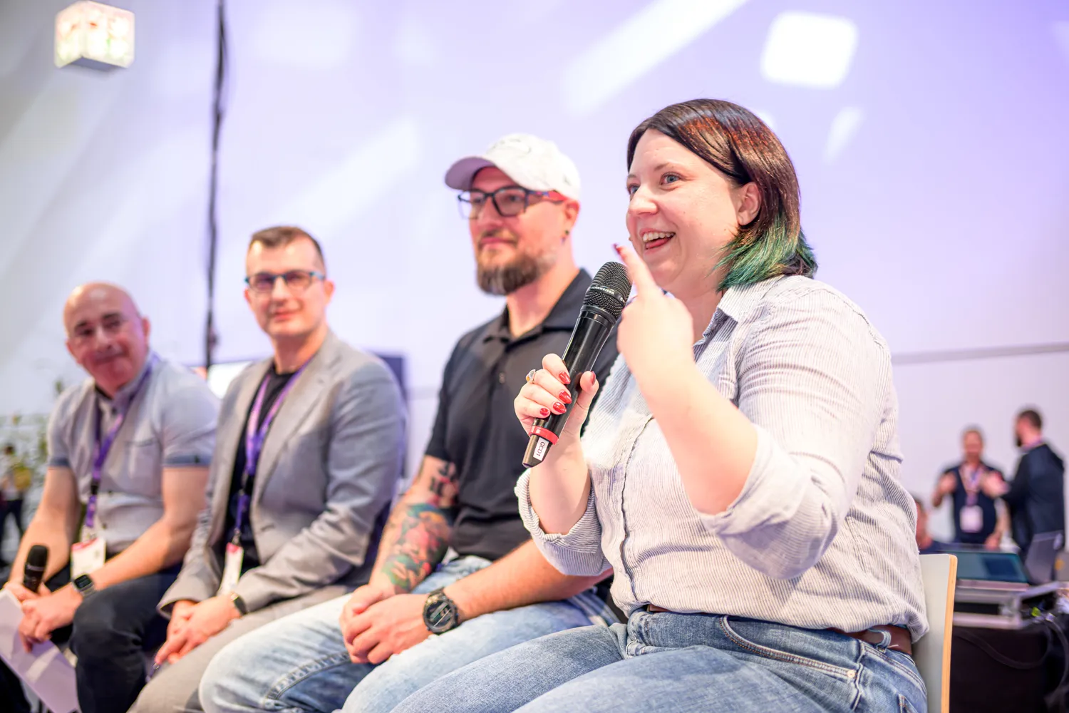 Four speakers seated in a panel discussion at ECS
