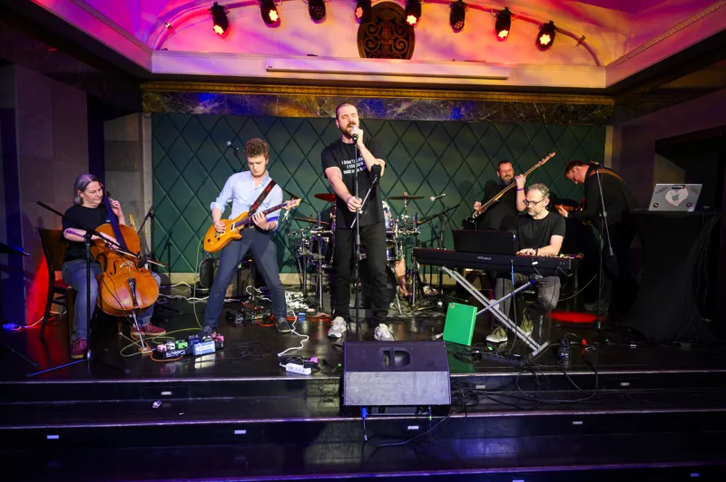 A band with a vocalist playing on stage at the ECS Party