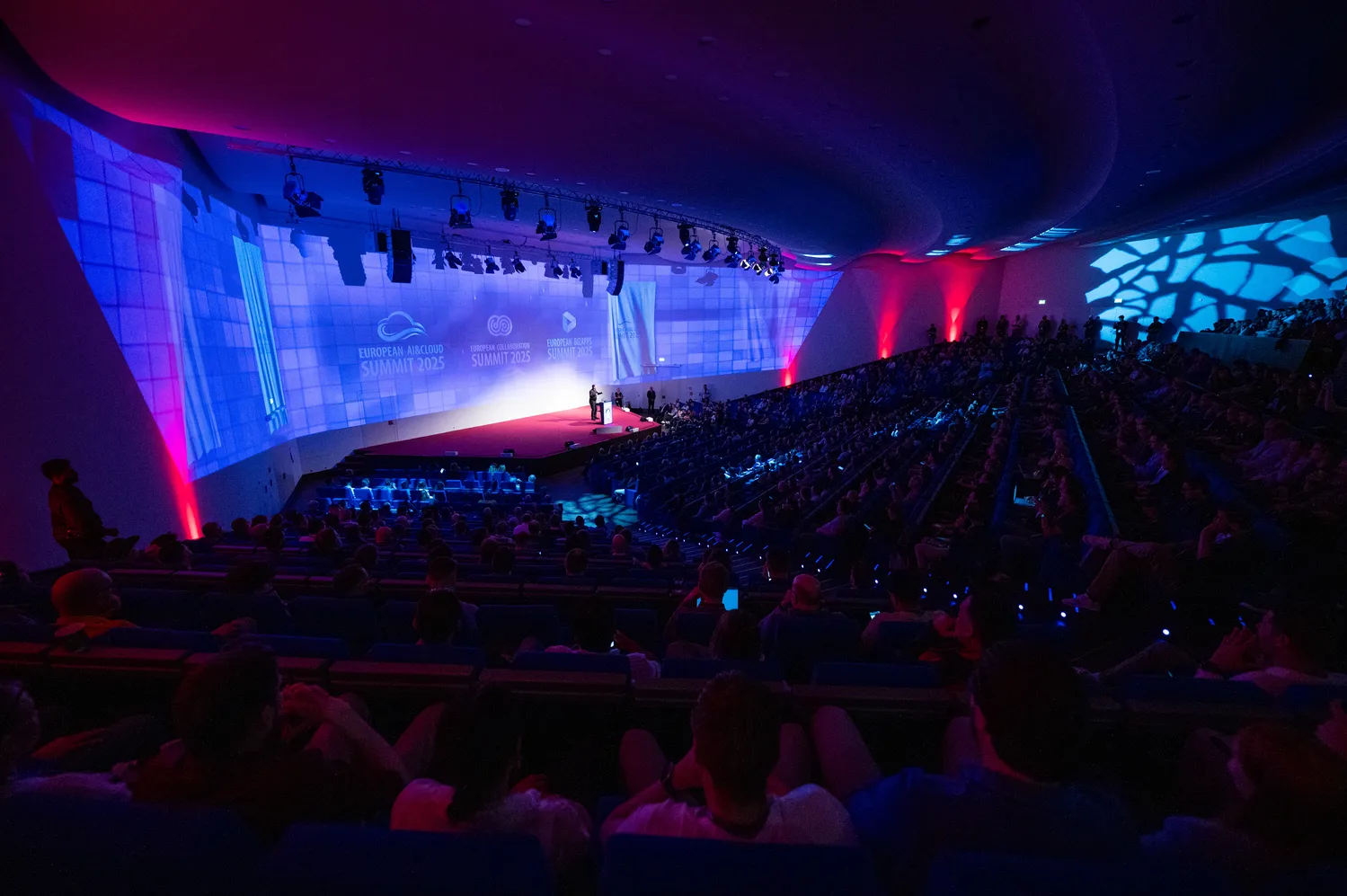 An audience in a modern session room at ECS