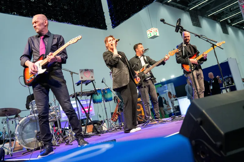 A four-piece band on stage at the ECS Party