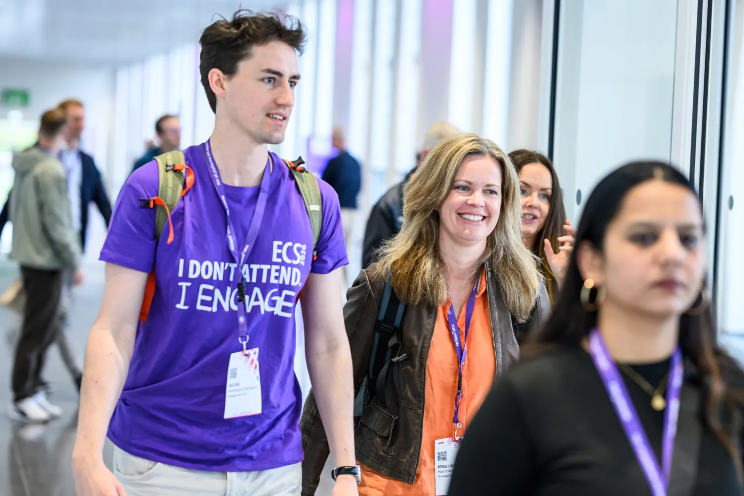 Attendees talking and laughing during a break at ECS