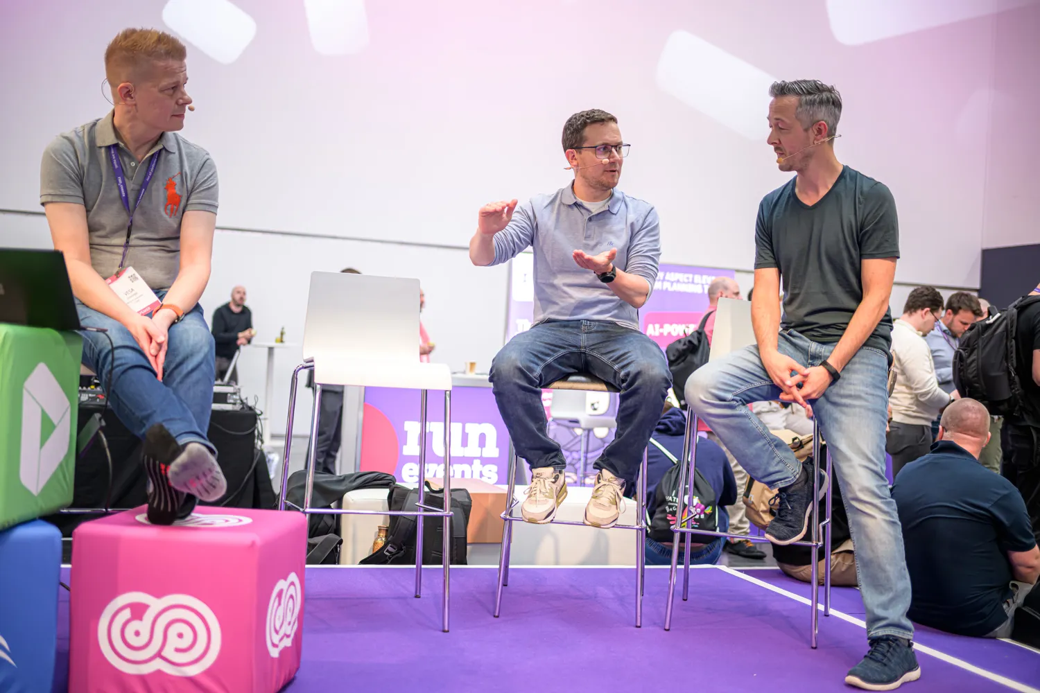 Three speakers in a panel discussion on an ECS stage