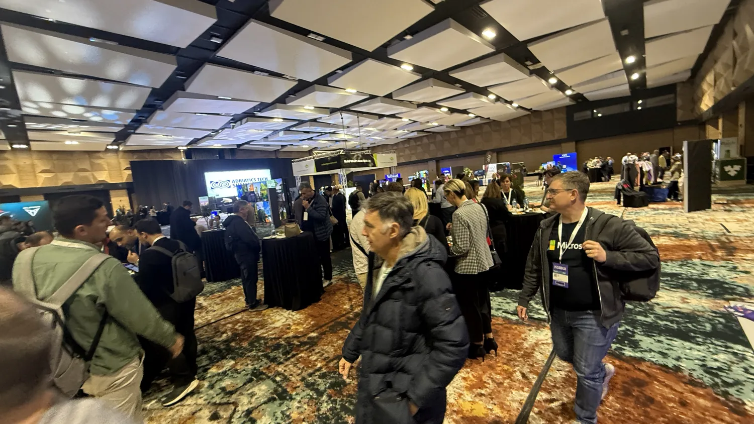 Industry professionals meeting at conference booths