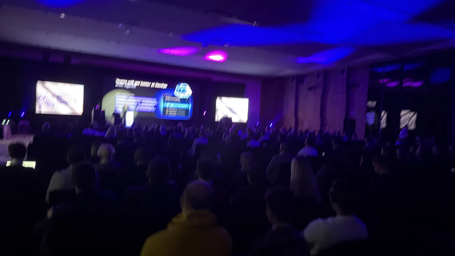 Delegates seated during a conference presentation