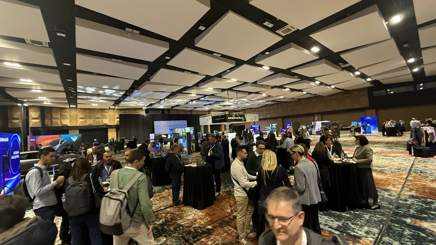 Delegates talking to an exhibitor at a technology stand