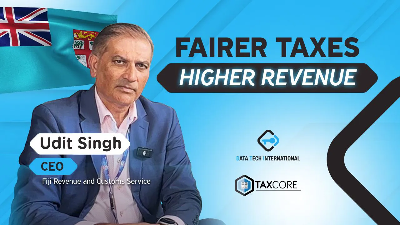 A professional man in a suit presents on a topic related to tax reform. The image includes logos for Fiji Revenue and Customs Service, Data Tech International, and TaxCore alongside flags and bold text emphasizing fairer taxes for higher revenue.