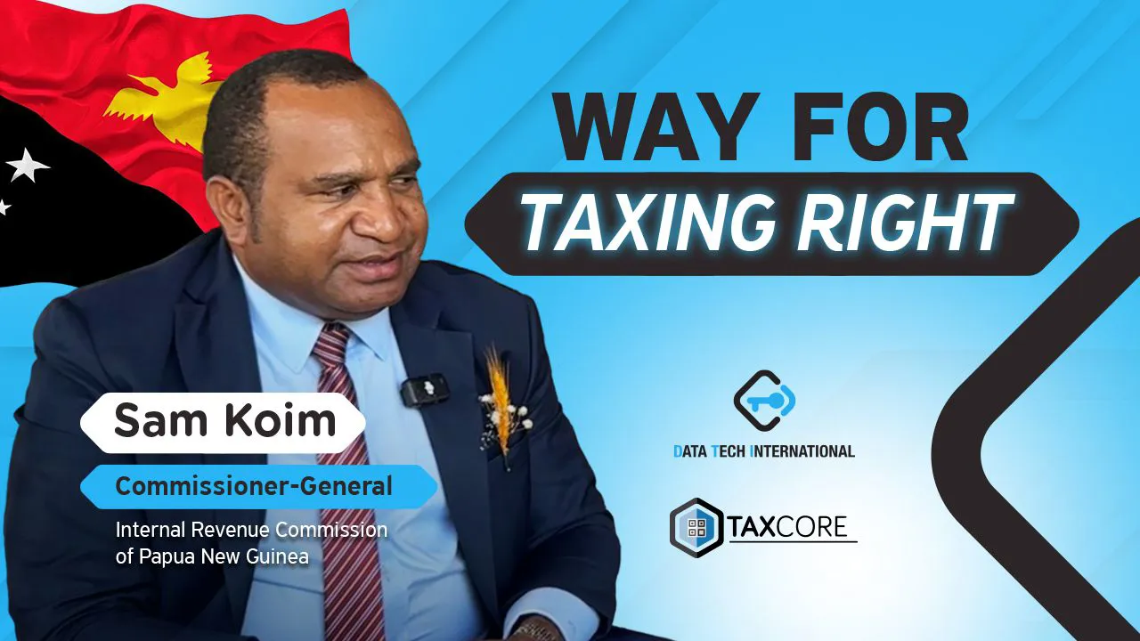 Professional portrait of Sam Koim, Commissioner-General of the Internal Revenue Commission of Papua New Guinea, speaking on tax reform initiatives. The background features the national flag and branding for "Way for Taxing Right" alongside logos from Data Tech International and TaxCore.