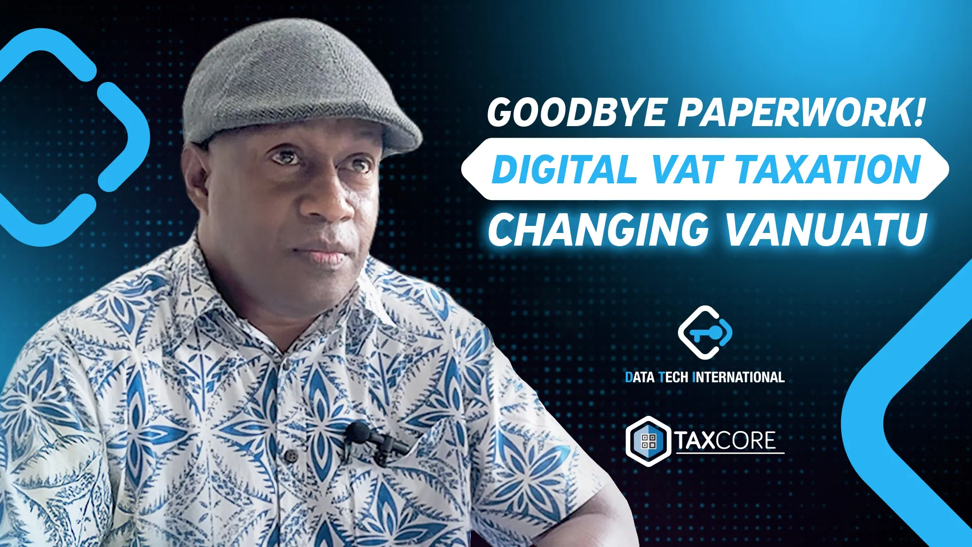 A man in a patterned shirt and cap speaks thoughtfully during a presentation on digital tax reforms. The background highlights the topic of transitioning from paper-based VAT taxation to digital systems in Vanuatu.