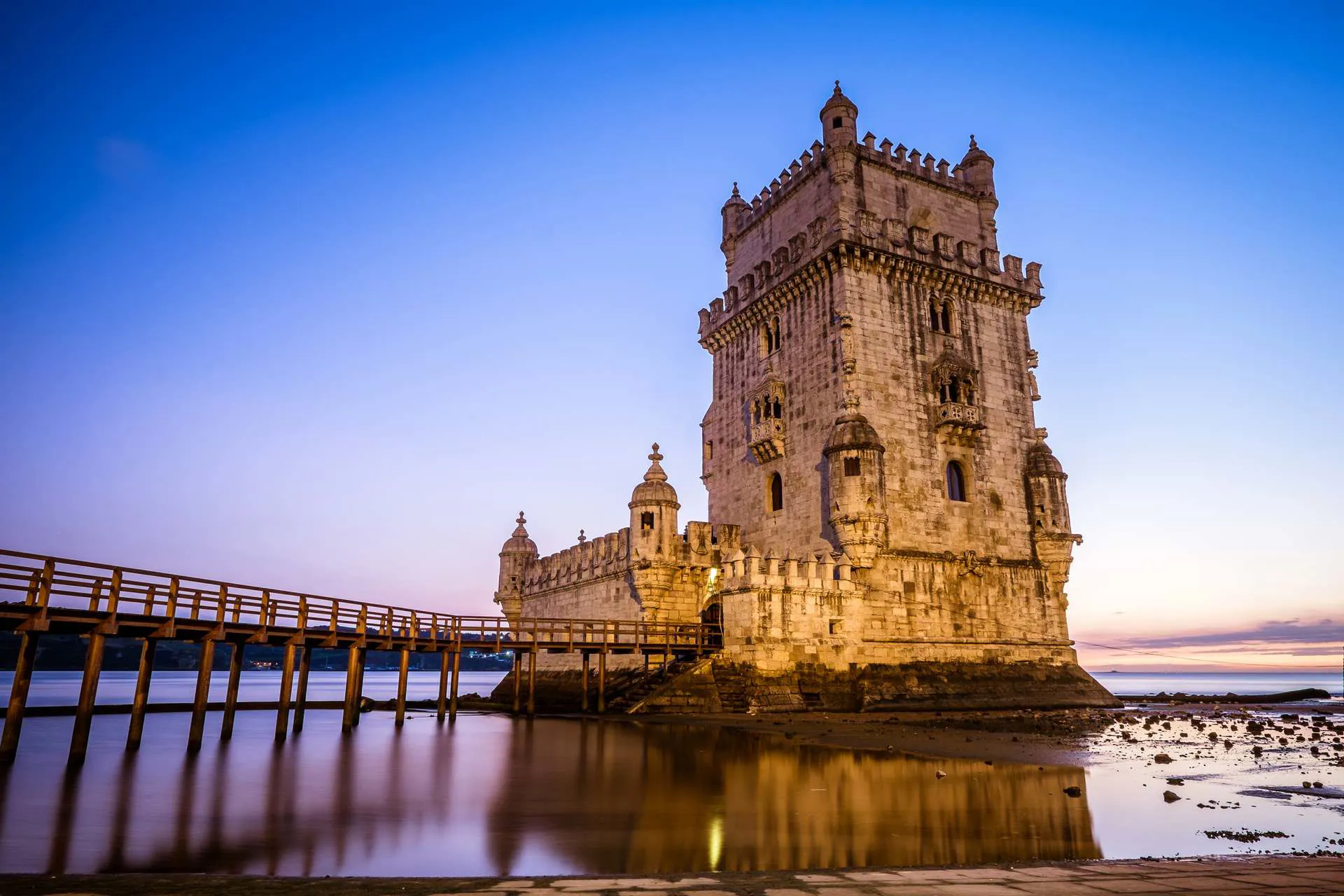 Historic stone tower along the waterfront at dusk in Portugal
